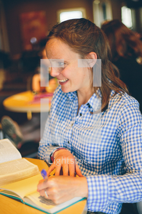 Smiling woman at a Bible study.