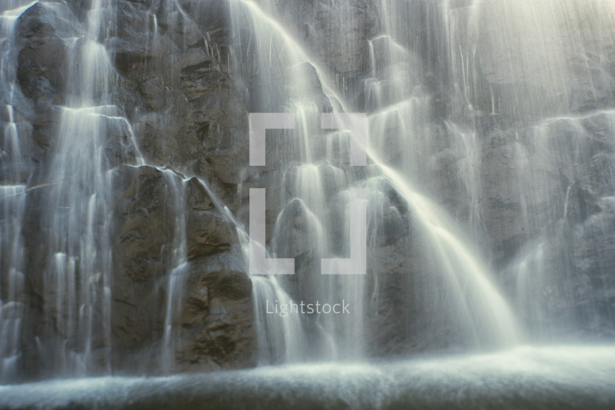 cascading waterfall down the side of a cliff 