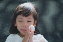 praying child with a hurt hand 