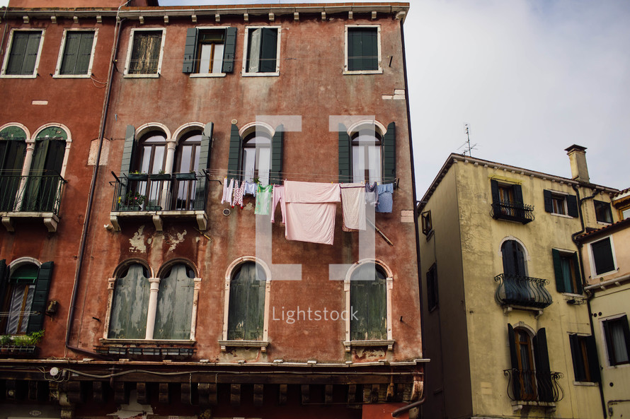 laundry on a clothesline hanging between windows in Venice 