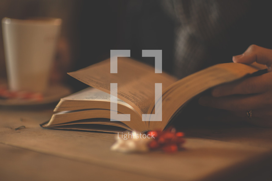 a man reading a Bible and Christmas bows 