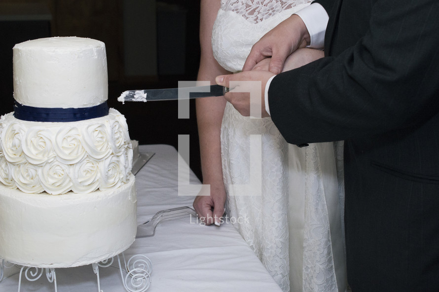bride and groom cutting a wedding cake 