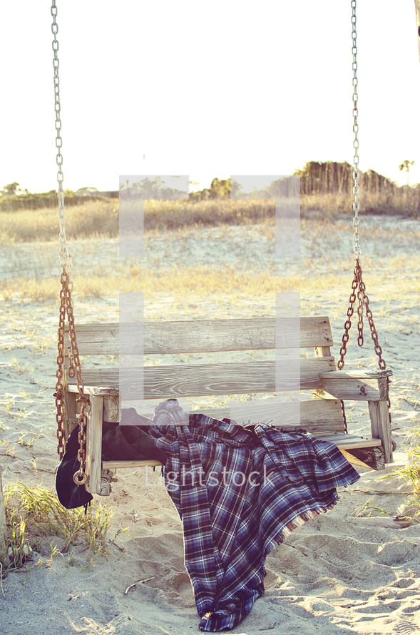 a blanket on a swing 