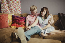 Couple sitting on couch smiling