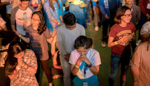 people praying at a concert 