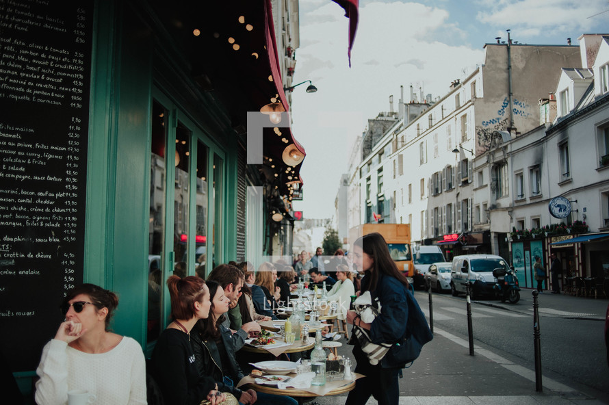 diners eating at outdoor seating at a cafe in Paris 