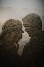 double exposure of a man and woman against the ocean 
