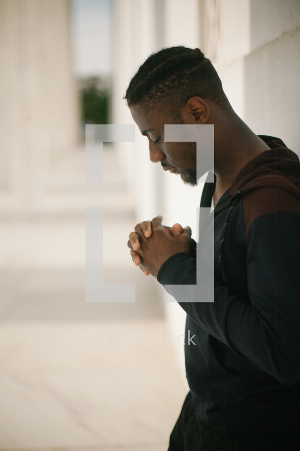 African American young man praying 