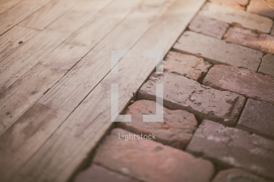 Wood planks adjoining bricks.