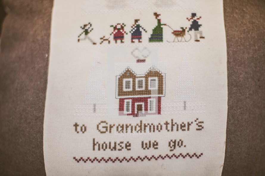 Needlepoint sampler depicting grandmother's house.