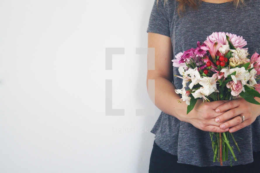 female holding a bouquet of flowers 