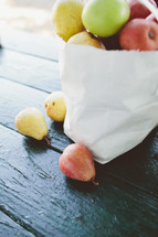 pears and apples in a white bag