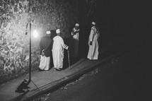 Islamic men walking down a dark street