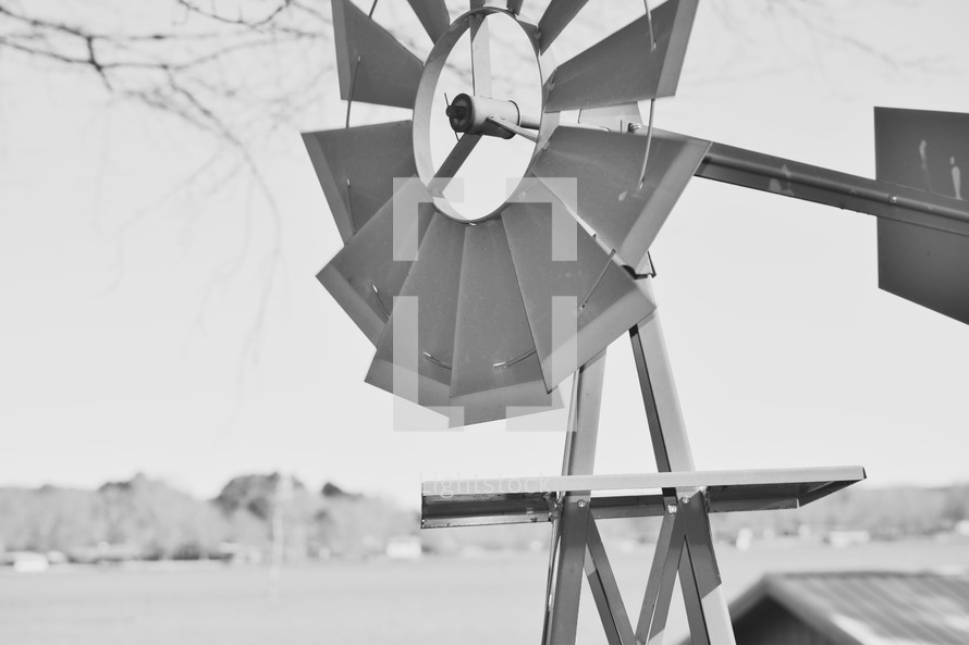windmill by a lake in black and white 
