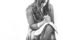 Praying women with open bible