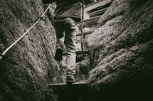 a child climbs some steps in a rocky crevice