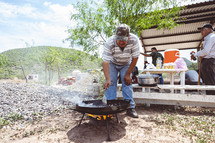 Men cooking food outdoors in Mexico 