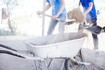 men shoveling dirt into a wheelbarrow in Mexico 