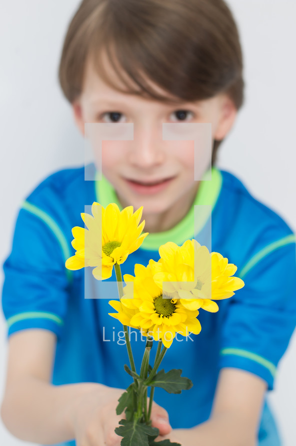 boy child holding a bouquet of picked flowers 