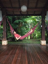 A man resting in a hammock. 