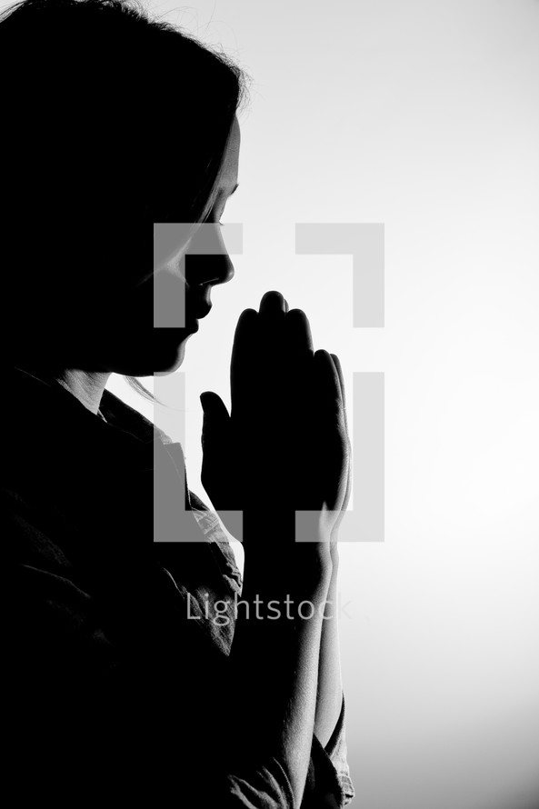 woman in prayer against a white background