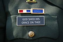 God Shed his grace on thee on a military name badge of uniform.