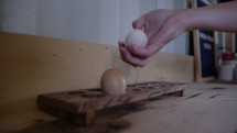 woman placing eggs on a countertop 