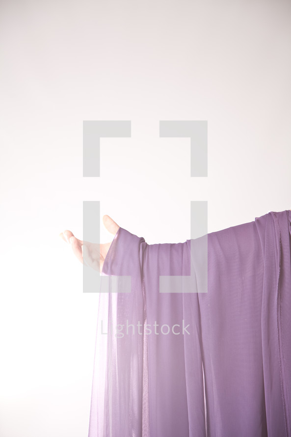 arm draped in purple cloth