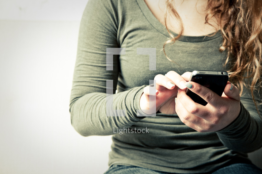 Girl's hands using smart phone.