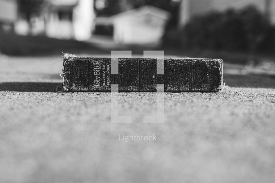 old Bible on concrete 