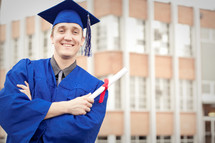 Smiling graduate with diploma.