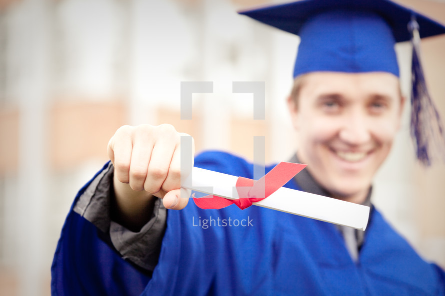 Smiling graduate with diploma.