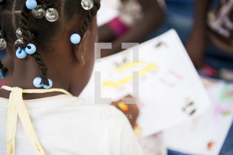 little girl coloring in the Dominican Republic-