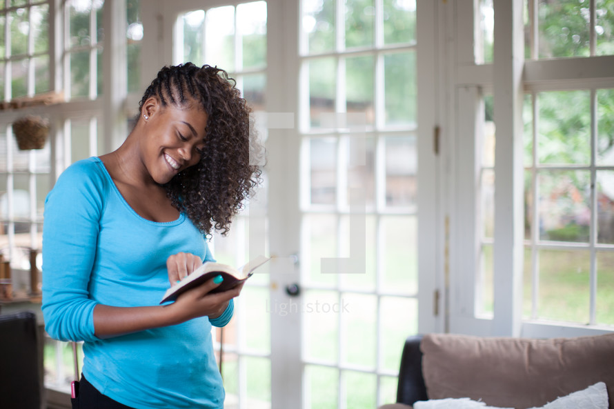 woman reading a Bible to a group at a Bible study 
