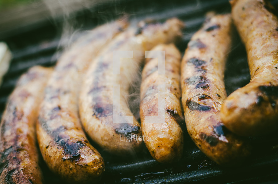 sausages cooking on a bbq grill