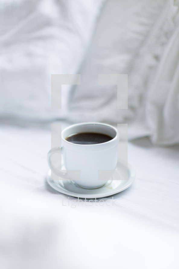 coffee cup on a bed 