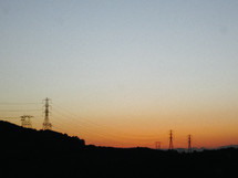 power lines and power poles at sunset 