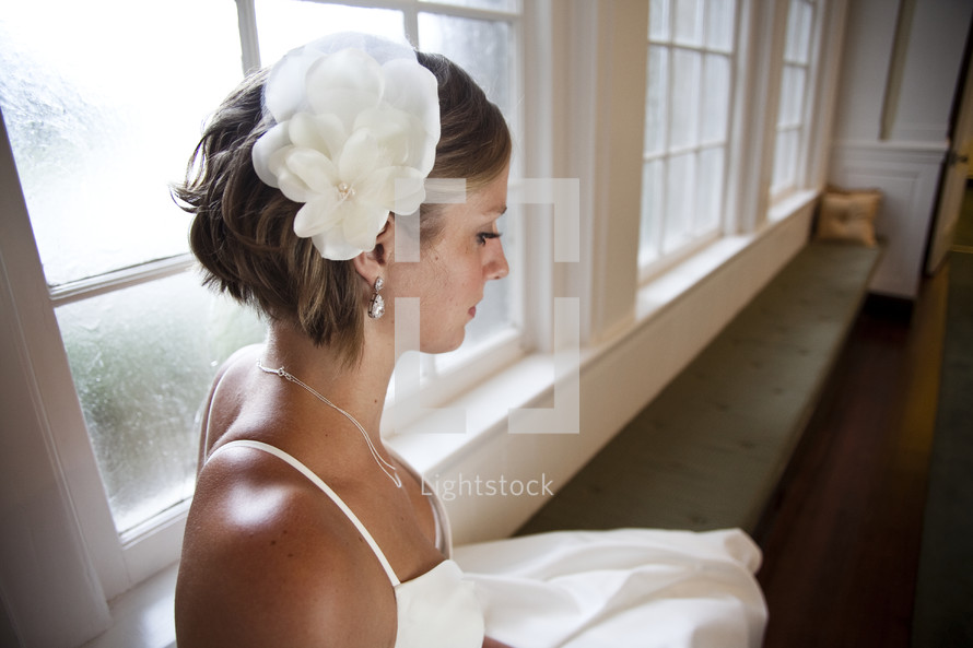 bride sitting on a window bench