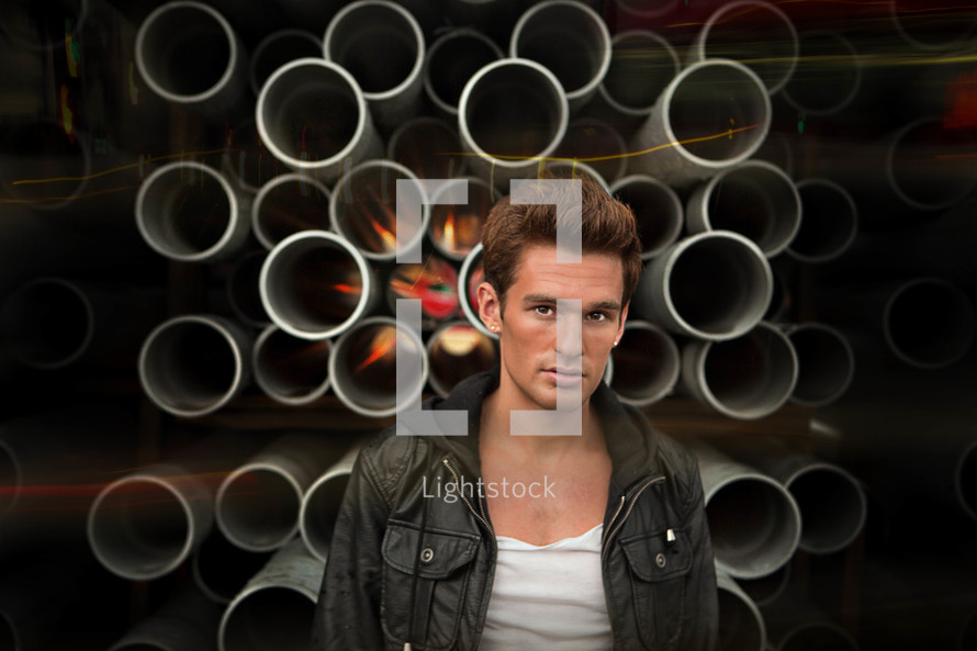man standing in front of pipes