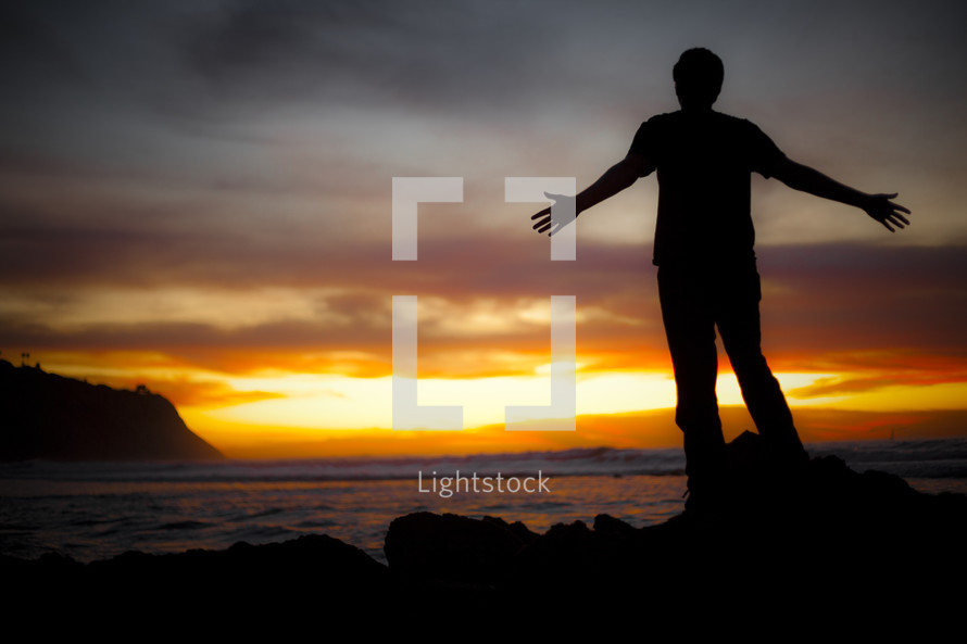 Man standing on beach watching sunset - God is my salvation