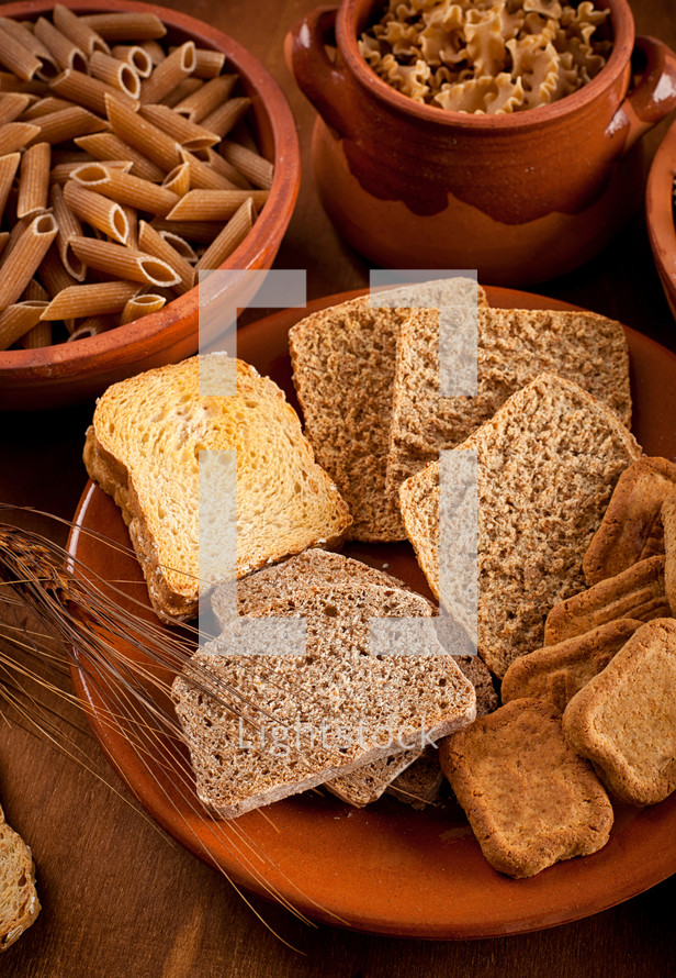 Whole grain carbohydrates on wooden table
