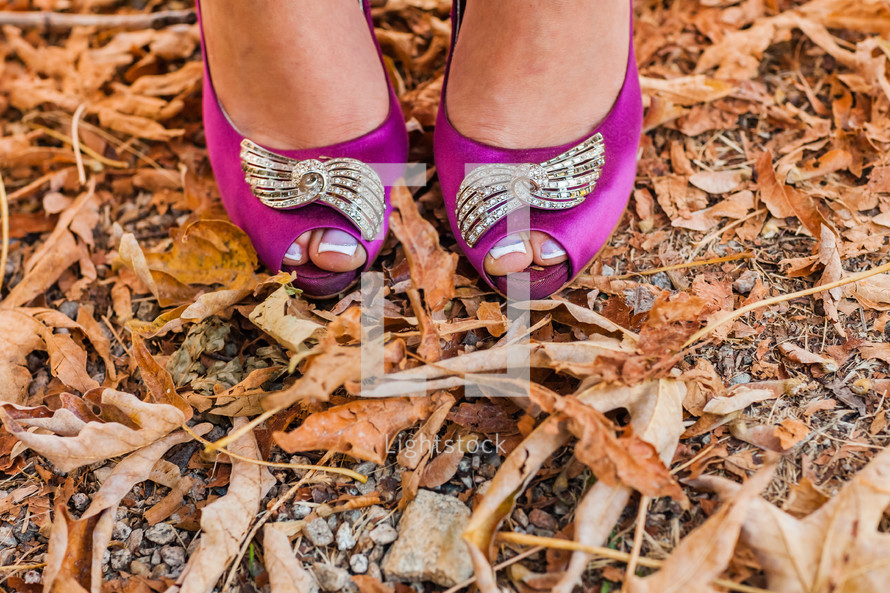 toes peeking through pink dress shoes fall leaves