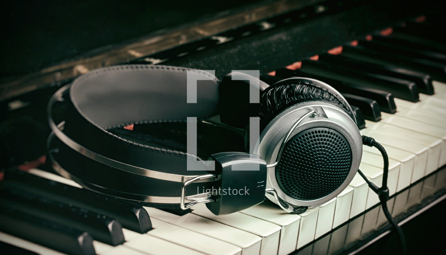 Piano keyboard with headphones for music