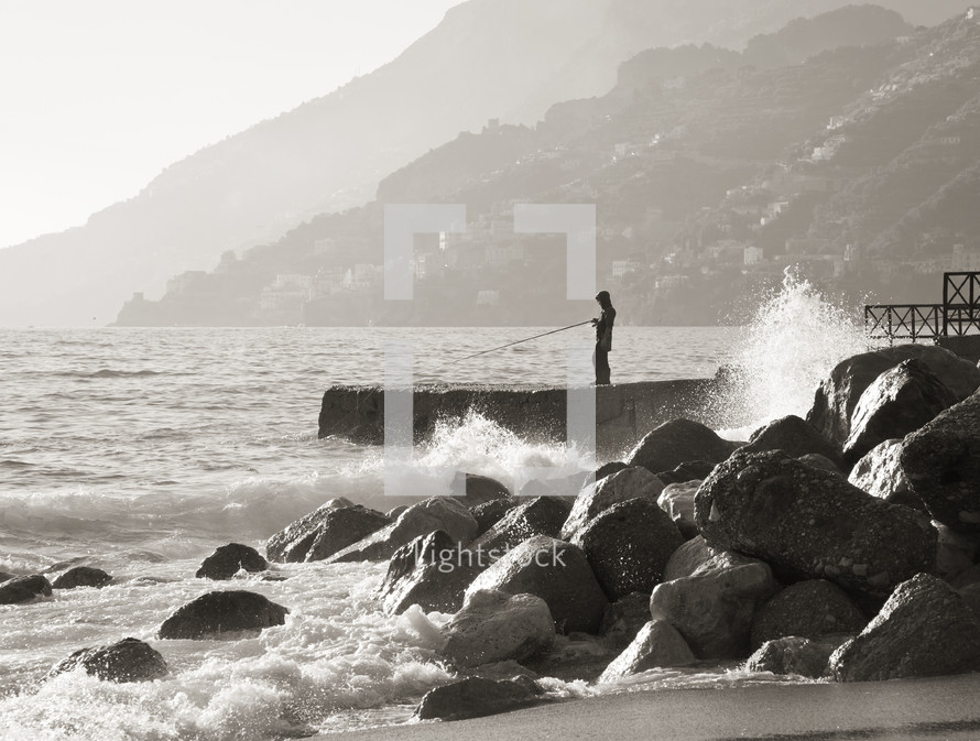 Fisherman while fishing on the rocks of Maiori, Amalfi Coast. Italy