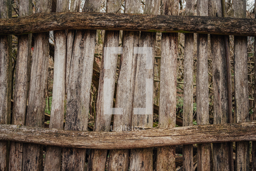 Outdated wooden fence in old village, wood planks, texture. High quality photo