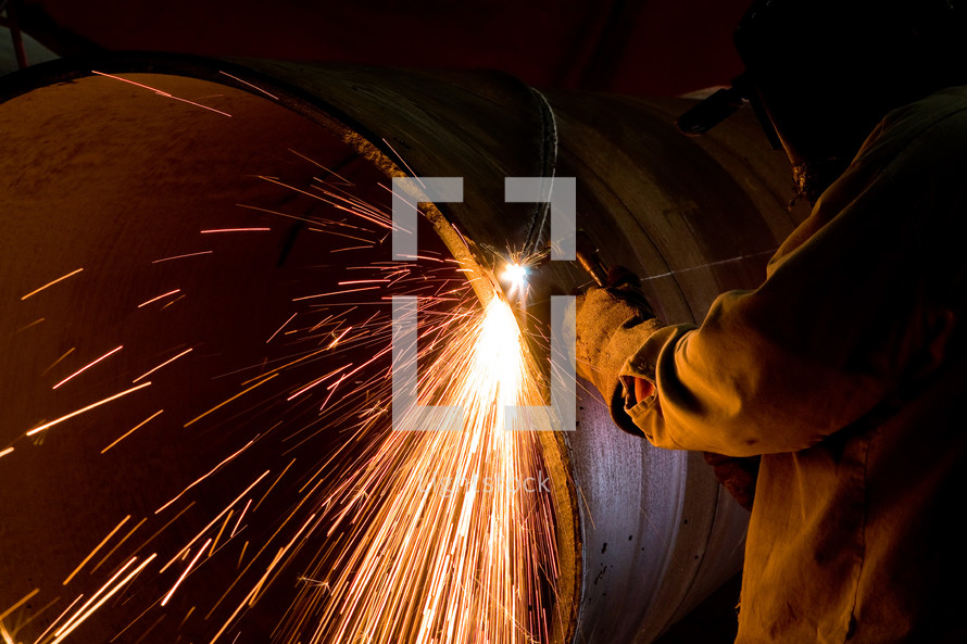 Welder torch cutting steel air arching sparks heat welding industrial shop