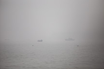 a ship on water and fog 