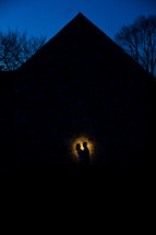 silhouette of a couple in a spotlight outdoors 
