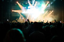 stage lights and silhouettes of audience members at a concert