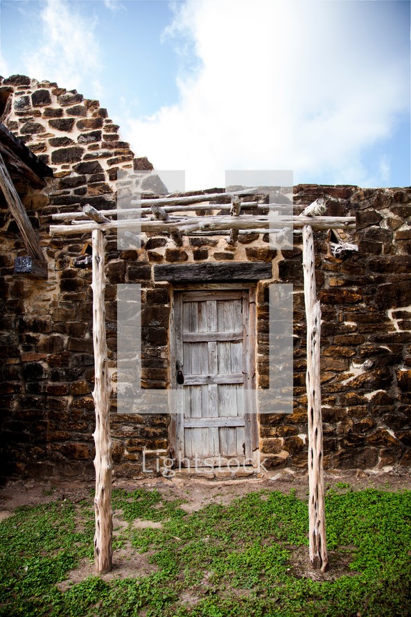 arbor in front of an old wood door